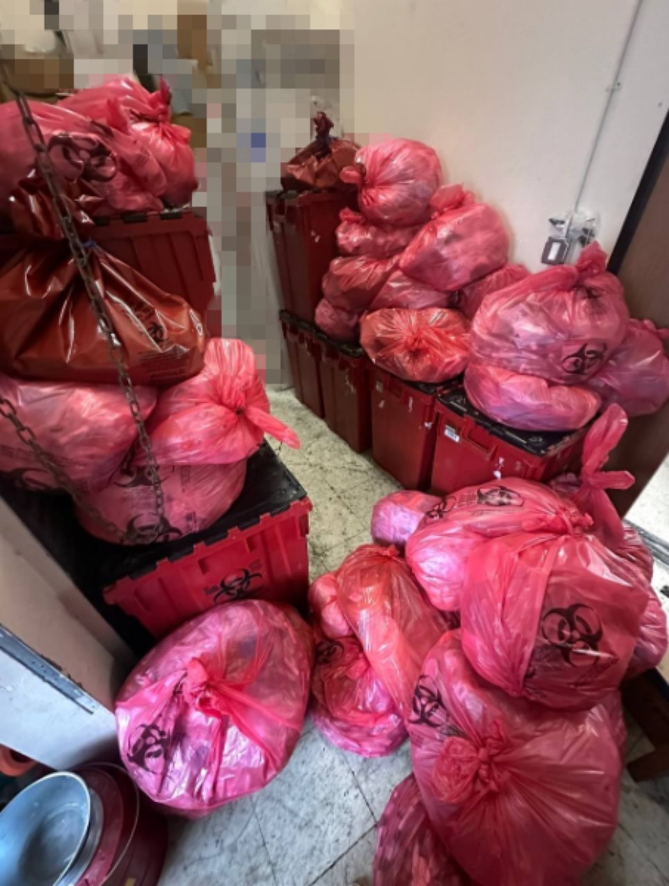 Before: diagnostic lab storage area overwhelmed with red biohazard waste bags and containers