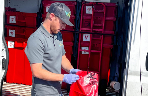 Eco Medical team member loading biohazard waste containers